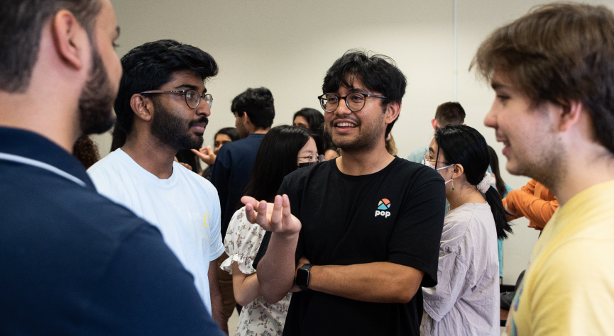 Standing group of students having discussion in class