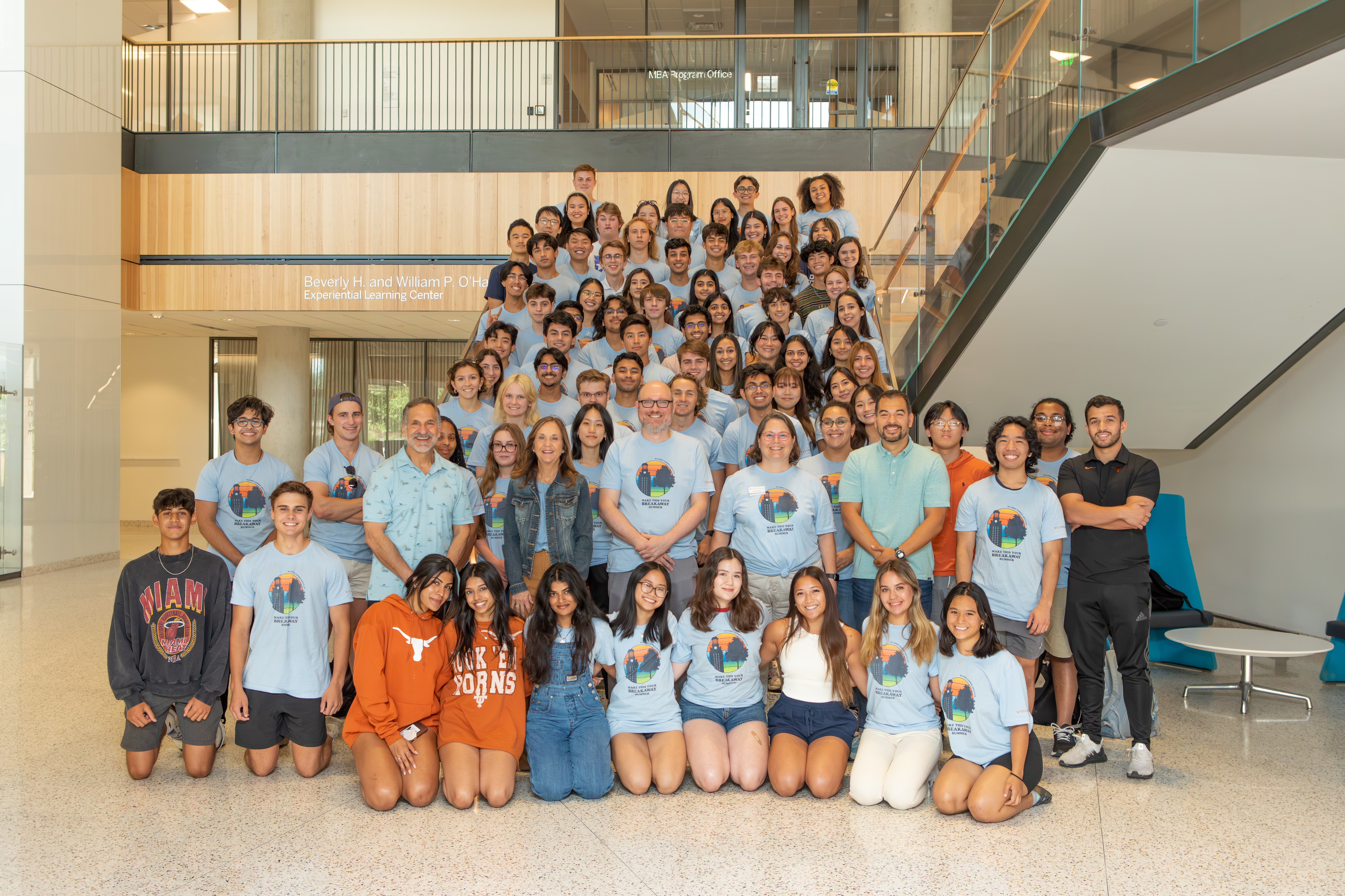 Large group of students posing on a staircase