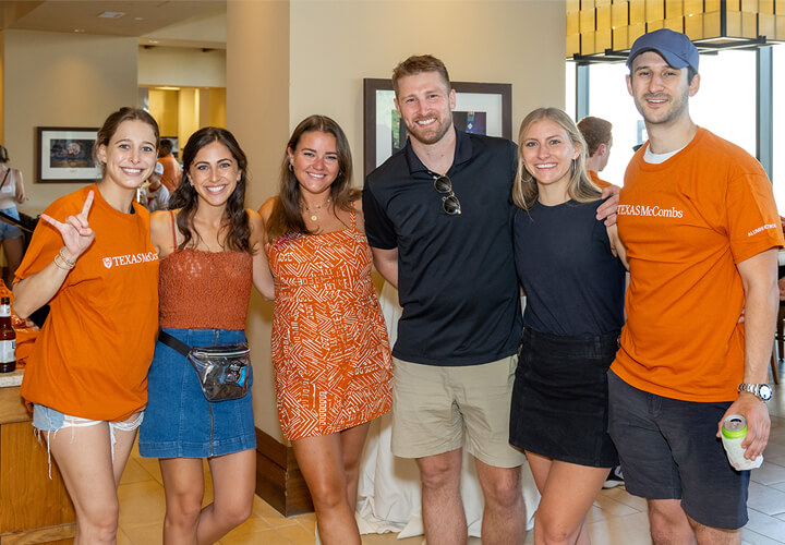 Group of smiling McCombs alumni