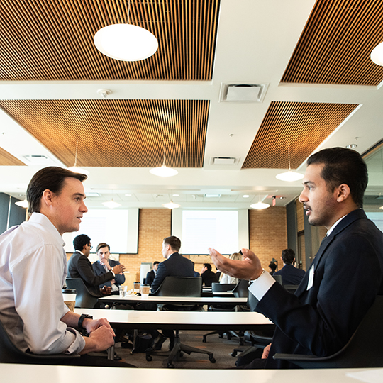 Event attendees sit and talk in Legacy Events room