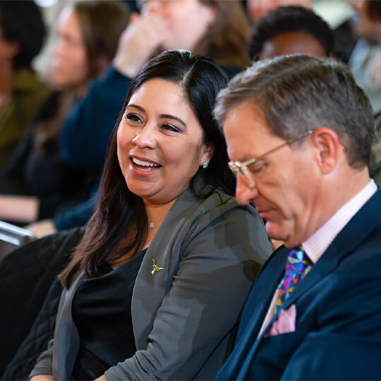 Two event attendees talk together