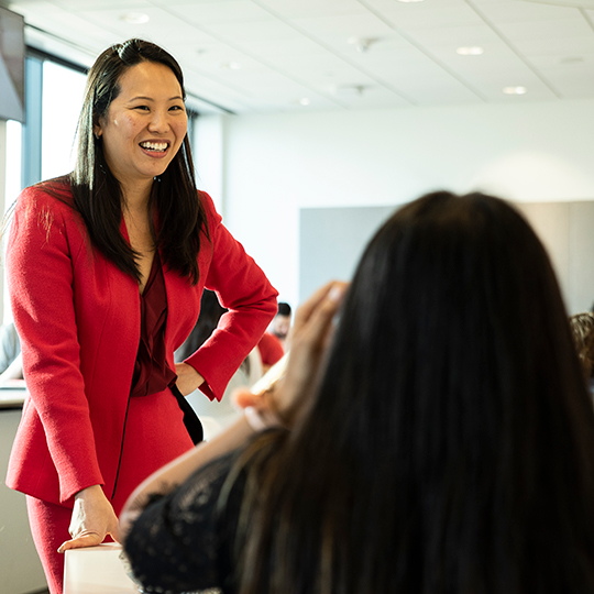 Impact chat speaker stands with hand on hip