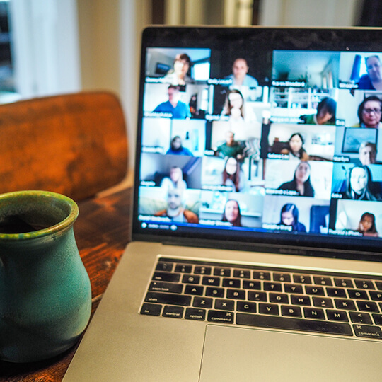 Multiple video conference screens on a laptop