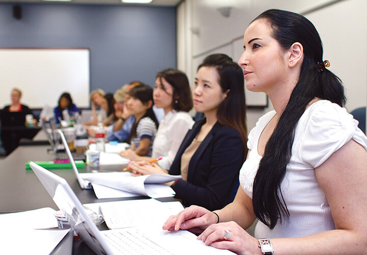 Female students sitting in a classroom looking at professor