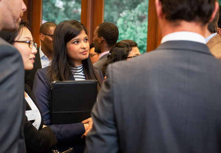 Several business casual students networking