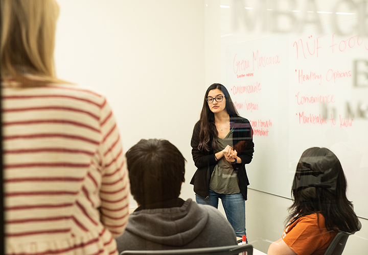 Student speaks at front of class