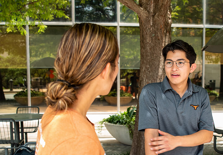 Two entrepreneurship minor students speak outside