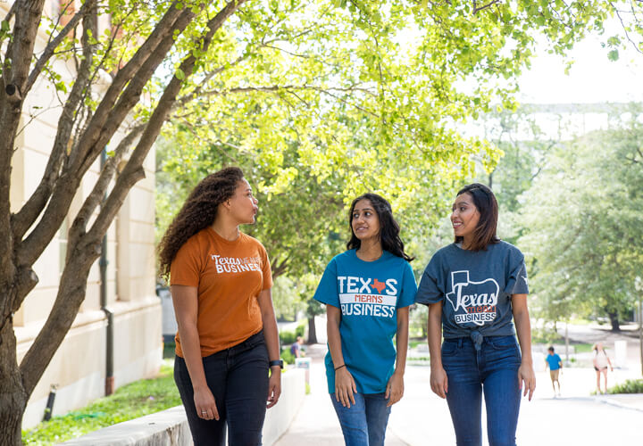 Three students walking on campus