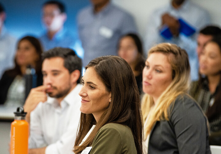 Students listening attentively at MBA orientation