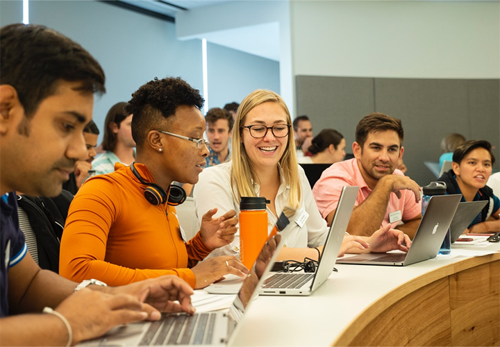 students talking during MBA class