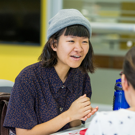 Closeup of student mentor talking in lab