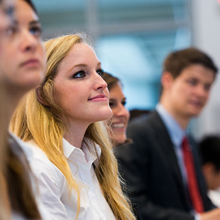 Closeup of MSITM students listening in class