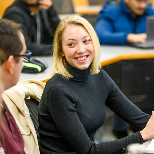 MS Program student smiles in class