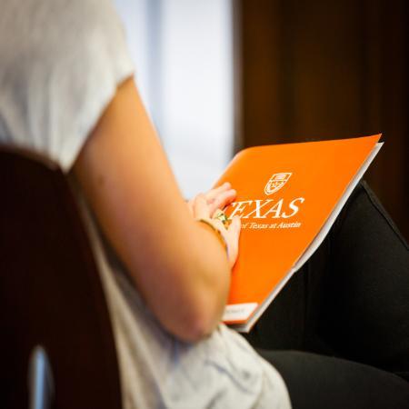 Student Holding a Texas folder