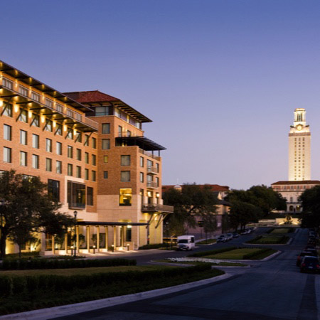 University building and tower with evening sky.