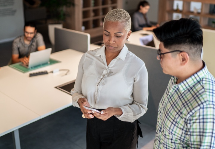 Two business people talking in an office.