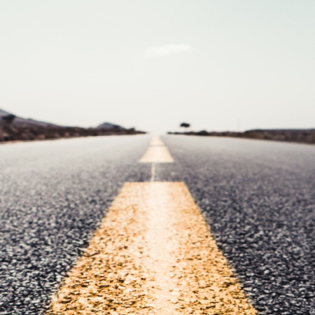 Looking down the yellow dividing line of a road.